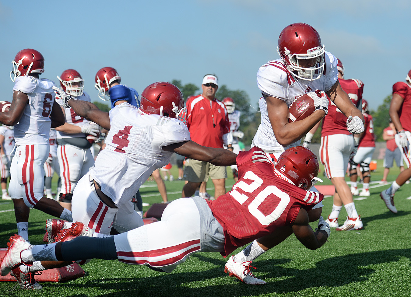 Wide receiver Ricky Jones (4) tries to block defensive back Jameel Cook Jr. (20) in the Oklahoma Drill. Mangieri says the drill is one of Coach Wilson’s favorites — and a good way to see what players are made of. Mangieri calls it man-on-man, bone-on-bone “fun.” | Photo by Mike Dickbernd