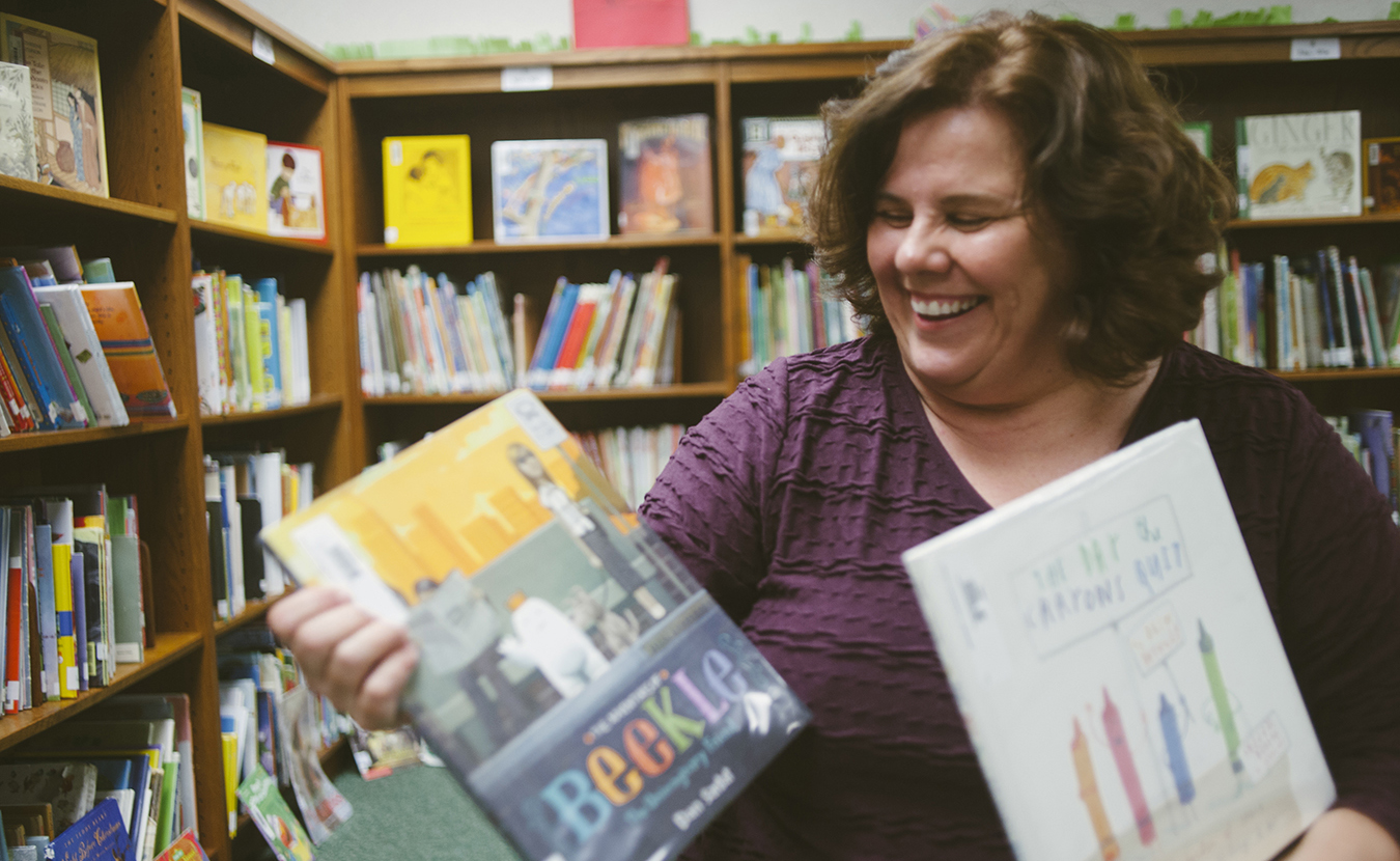 Mary D'Eliso, who has been the librarian at University Elementary School since 2004, shares some of her favorite children's books. | Photo by Natasha Komoda