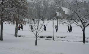 People walk, going along their business as usual despite the snow, through Dunn Meadow between Jordan River and East 7th Street. | Photo by Ann Georgescu