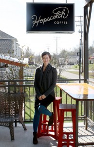 Jane Behnken, co-owner of Hopscotch Coffee, sits on the coffee shop's porch, which faces the B-Line Trail. | Photo by Jonna Mary Yost