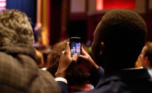 A member of the crowd captures the event on their phone. | Photo by TJ Jaeger