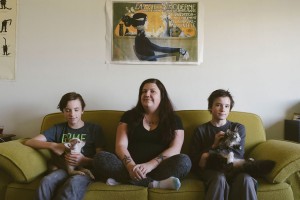 Laura Reagan sits with her twin sons, Korbyn (left) and Jarek, and their dog, Sancho, and cat, Squishy. Reagan has dealt with food insecurity on and off throughout her entire life and has worked very hard to protect her sons from the stress of being food insecure. | Photo by Natasha Komoda