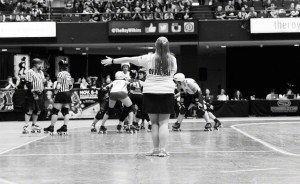 Bekka Potter, whose roller derby name is Silken Tofu, clocks a time out during the Women's Flat Track Roller Derby Association's (WFTDA) Championship Tournament in fall 2015 in St. Paul, Minnesota. Tofu is one of the top four WFTDA-certified Non-Skating Officials (NSOs) in the world. | Photo by Bob Ayers