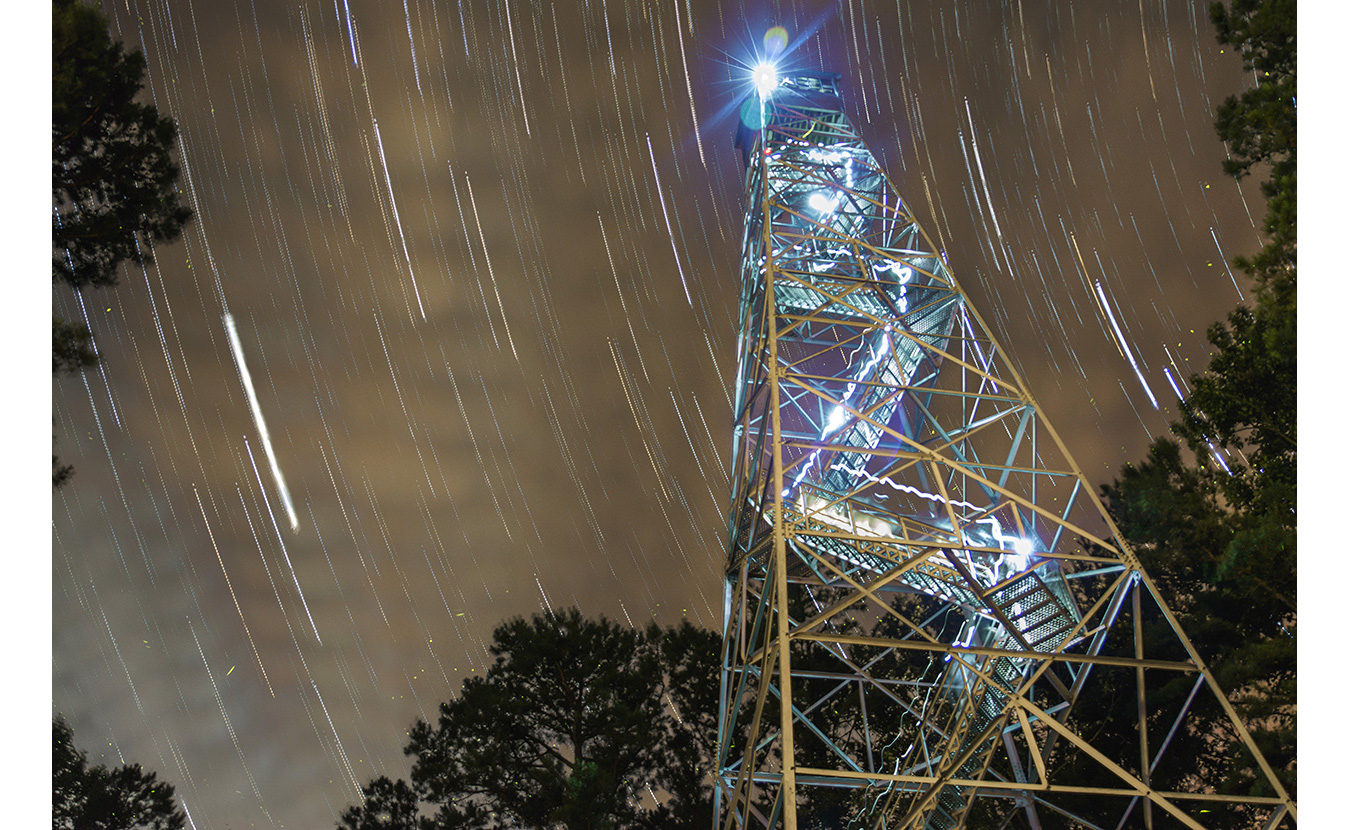 Clark set up his camera for a time lapse at the bottom of the Charles C. Deam Wilderness Area fire tower. After it was complete, he stacked 175 images and blended them using a program called StarStaX. The light from his head lamp was also caught in the pictures as he climbed to the top. | Photo by Nathan Clark