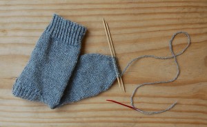 Lindsay Welsch Sveen chose to knit socks using the yarn from Marble Hill Farm's fleece crop. This photo shows the satisfying last step of sock knitting: stitching the toe closed. | Photo by Lindsay Welsch Sveen