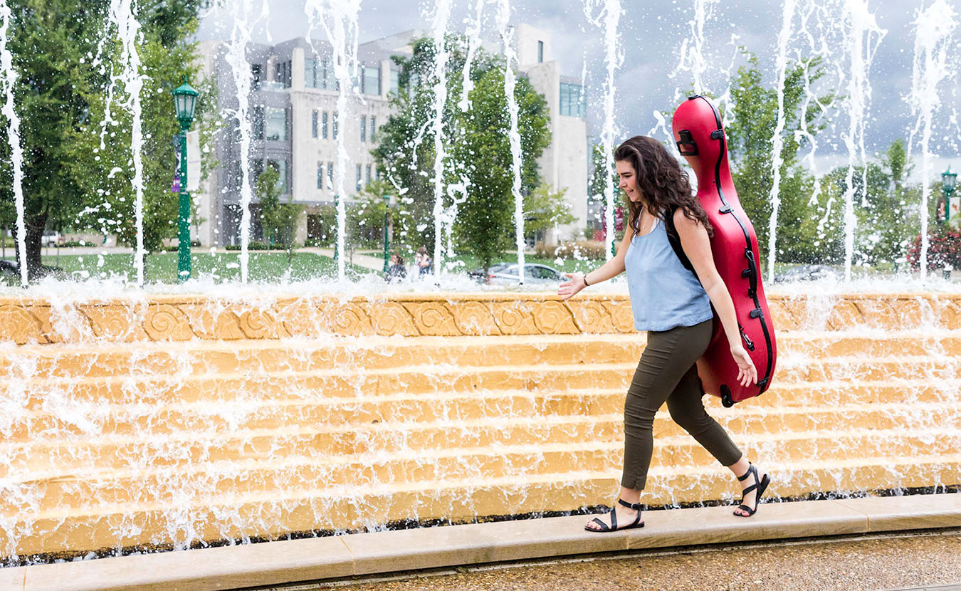 Miller Susens walks through the Indiana University campus carrying her cello. Susens is studying music education in the Jacobs School of Music and often finds herself having to defend her major. | Photo by Ben Meraz