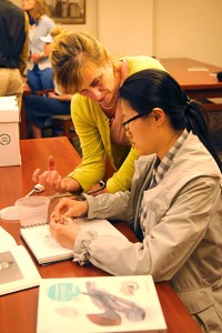 Nicole Jacquard (left) working with BFA student Ge Bai during a trip to Wells Library to work with Eikerman's archives. | Photo by Ann Georgescu
