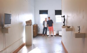 Artists William Bass, left, and Raphael Cornford stand at the end of their downtown gallery space, NOISE. Writer Lindsay Welsch Sveen says a new art scene is emerging that offers “hip alternatives to the institutions." | Photo by Samuel Welsch Sveen