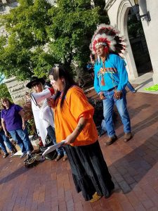 Writer Laura Reagan, center, wear traditional Apache dress while speaking to a group of people at Sample Gates. As Halloween approaches, consider if your costume appropriates another's culture. | Courtesy photo