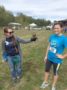LP sponsored the Run for the Animals to benefit the Monroe County Humane Society. Pictured here, -r: WildCare Inc. volunteer Carlee, Felix the kestrel, and Emily.