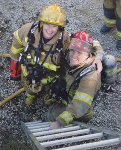Jean Magrane (left), who became Bloomington's first woman firefighter in 1987, with Greg Lucas at the “Jiffy Treat training day” in 2006. The fire department is often allowed to use condemned buildings for training purposes before the buildings are destroyed, such as the old Jiffy Treat on Kirkwood Avenue. | Courtesy photo