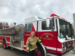Magrane with fire truck during a recent girl scout fire camp that she helps organize. | Courtesy photo