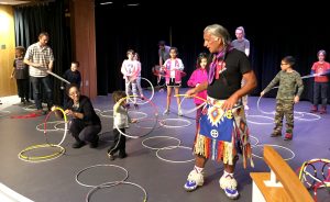 Kevin Locke, foreground, teaches local kids about Hoop Dance at the Monroe County Public Library this spring. (See the end of this story for a video of Locke performing a Hoop Dance.) | Limestone Post
