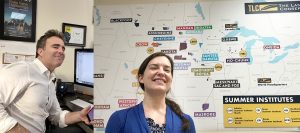 Mitch Teplitsky, right, TLC’s public relations and communications director, at his desk and Rebecca Mueller, TLC's events coordinator, with a map of the organizations' Summer Institute programs. | Courtesy photos