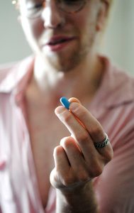 Syd Bohuk’s alarm dings, they swallow a bright blue pill, and continue with their day. Syd says this pill — PrEP, an HIV preventative medication — has become a part of their daily routine, and is much less scary than they had originally anticipated. | Photo by Nicole McPheeters