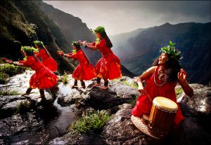 Performing the "hula kahiko," or ancient Hawaiin hula, dancers blend simple footwork with hand gestures to illustrate the myths and histories of their families on the rim of the Waimea Canyon on Kauai. | © Steve Raymer / National Geographic Creative