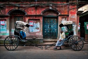As if in a scene from the early twentieth century, rickshaw-pullers rest on a backstreet in Calcutta, now renamed Kolkata, capital of the Indian state of West Bengal. The city's some six thousand licensed rickshaw drivers are often called "human horses" generally earn less than five dollars a day navigating the city's crowded and sometimes flooded streets. | © Steve Raymer / National Geographic Creative