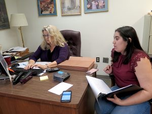 Diane Walker, executive director of District 10 Pro Bono Project, works at her desk with Alexxis Lara, a law student intern. | Limestone Post