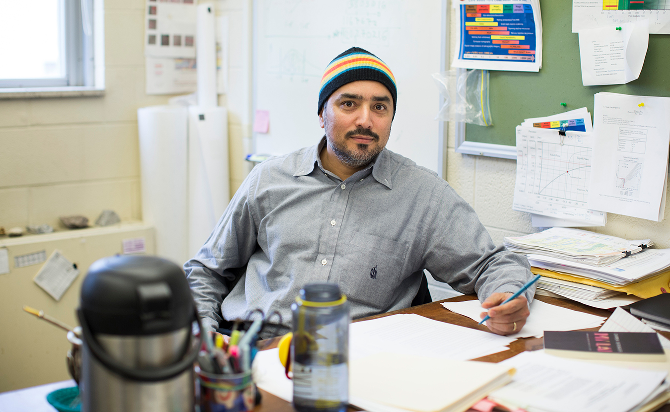 Cristian Medina, a poet, cook, IU researcher, and chess leader from Arica, Chile, moved to Bloomington in the mid-2000s. Pictured here, Medina sits at his desk at the Indiana Geological and Water Survey. | Photo by Chaz Mottinger