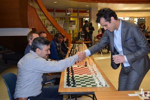 Medina, left, shakes hands with grandmaster Fidel Corrales, who visited Bloomington and played a simul game in December 2017. | Courtesy photo