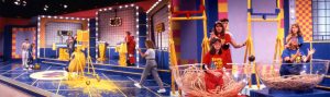 Families participate in challenges during Nickelodeon's 'Double Dare' in 1990. Considered one of the messiest TV shows, someone dressed as a "hotdog bun" gets covered in "mustard" (left) and folks sitting in "spaghetti" try to catch falling "meatballs." | Photos courtesy of Public Domain