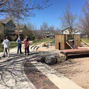 Wood, standing in center, speaks with residents on a common green path during a tour of Greyrock Commons in Fort Collins, Colorado. The Greyrock Commons design is similar to the planned design of the Bloomington Cohousing project. | Courtesy photo