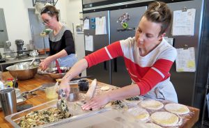 Jenson, left, and Armstrong — who are making hand pies and peanut butter brownies, respectively — say that when they slow down and enjoy their food, they tend to feel more satisfied and sometimes eat less. | Limestone Post