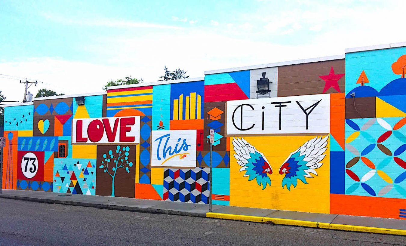 Photographer M.J. Bower photographed more than 30 murals in Bloomington to create a Bloomington Mural Trail. This mural, ‘Love This City,’ was painted by Eva Allen on the side of Mother Bear’s Pizza’s east-side location in spring 2019. The full list of murals is at the end of the article, as is a link to The Bloomington Trail Map. | Photo by M.J. Bower