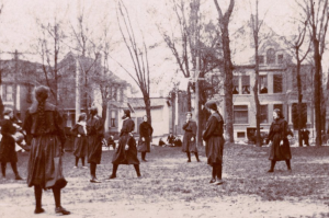 This photo, taken on April 22, 1899, shows a high school girls' game between Shortridge High School and the Y.W.C.A. in Indianapolis. A hoop and net (without a backboard) can be seen slightly above and to the right of center. The ball handler is to the left. The photo is titled ‘Shortridge High School and Y. W. C. A. girls playing basketball, Indianapolis, Indiana, 1899’ and provided courtesy of IndianaAlbum.com from the Nicolas Horn Collection.