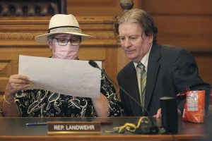 Kansas GOP State Reps. Brenda Landwehr (left) and Steve Huebert confer during a meeting of a House committee on redistricting on January 18, 2022, at the Statehouse in Topeka, Kansas. | AP Photo/John Hanna