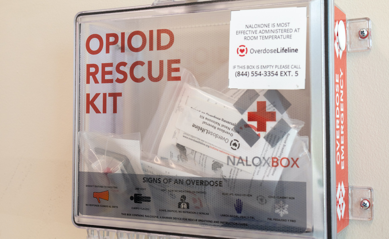 Bloomington and Monroe County have already received their first payments from the first opioid settlement, but none of it has been spent. Many health service providers wonder where the money will go. NaloxBoxes, like the one above at the IU Health Center, are among the uses approved by the state as part of the settlement documents. | Photo by Benedict Jones