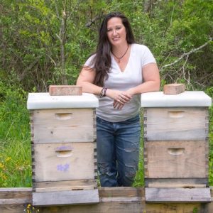Beekeeping instructor and former sole proprietor of The Virtual Bee, Jennifer Bland, with two of her hives. | Courtesy photo