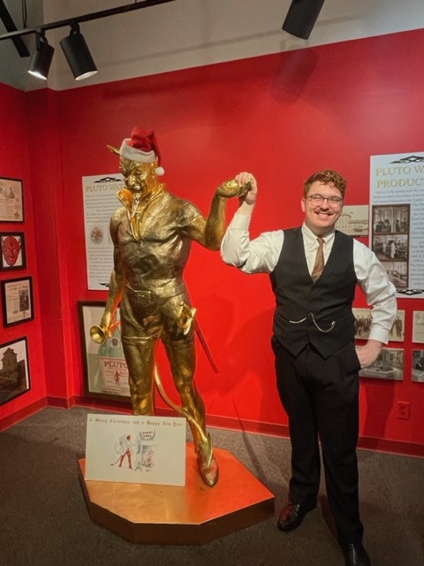 Kenton Allbright, assistant director of the French Lick Museum, with a statue of Pluto. | Photo by Laurie D. Borman