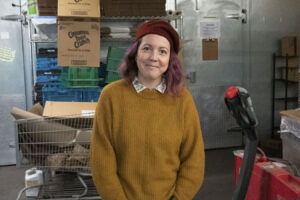 Megan Betz inside the warehouse of Mother Hubbard’s Cupboard. Betz is the CEO and President of the food pantry and community center. | Photo by Olivia Bianco