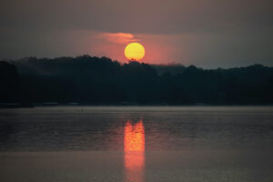 Sunrise on Lake Lemon, Monroe County, Indiana — The air was thick with smoke from forest fires. When the sun was cresting the horizon, the edges were so sharply defined. The scene was so dynamic and mysterious. I set my tripod up to get the clearest shot I could.