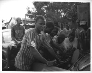 Le Mécanicien Automobile (The Mechanics), Conakry, Guinea, 2009, Gelatin Silver Print. Young men learn the art of being a mechanic in a small trade school.