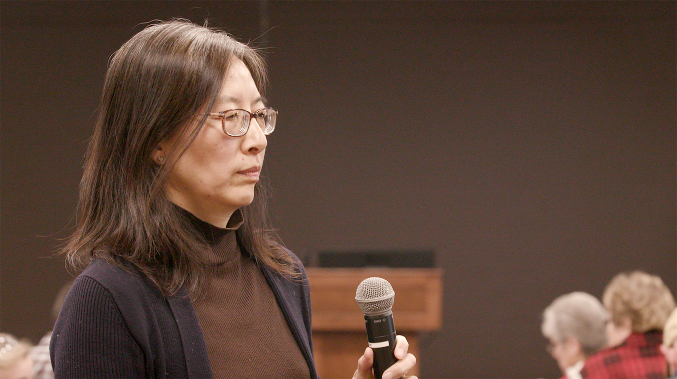 Liu listens as an audience member asks her a question during a Martinsville community meeting in February.