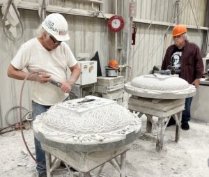 Ned Cunningham (left), a six-years-retired master stone carver, and Boyd Sturdevant work on their project in the mill at Bybee Stone Company in Ellettsville. Cunningham is carving one of the four sculptures they are producing to commemorate the total eclipse in April. Tap or click the photo to watch <a href="https://youtube.com/shorts/VF1uYWex6t0?feature=share" target="_blank"> a short video on YouTube</a> of Cunningham carving the limestone. | Limestone Post