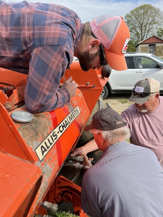 (clockwise from top) Zach Clark watches Kevin Zikes and Joel Clark attach hydraulic hoses to Zach's Allis-Chalmers during plow day.