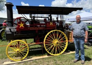 Tim Deckard, president of the Monroe County Antique Machinery Association, during the association’s show in May at the Monroe County Fairgrounds. He’s standing in front of an early 1880s Russell 10-horsepower steam tractor, which was first restored and exhibited in 1980 by Bob (“Papaw”) and Margie Hughes, then re-restored in 2023 by Bob (grandson) and Margaret Barnes. | Limestone Post
