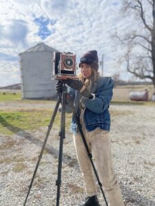 Megan Snook with her tintype camera. Cameras used in tintype photography are often large format field cameras that use plates measuring 4x5 or 8x10 inches. A tripod is used to steady the camera during the long exposure process. | Courtesy photo