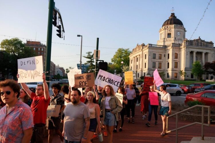 Activists gathered at the Monroe County Courthouse in 2022 for the “Take to the Streets — Defend Roe!” rally and march. Later that year, the U.S. Supreme Court ended federal protection of abortion rights across the country. Indiana then became the first state to pass an anti-abortion law, which, according to advocates for women’s health, has created confusion among doctors and endangered the lives of pregnant women. | Photo by Jeremy Hogan/The Bloomingtonian