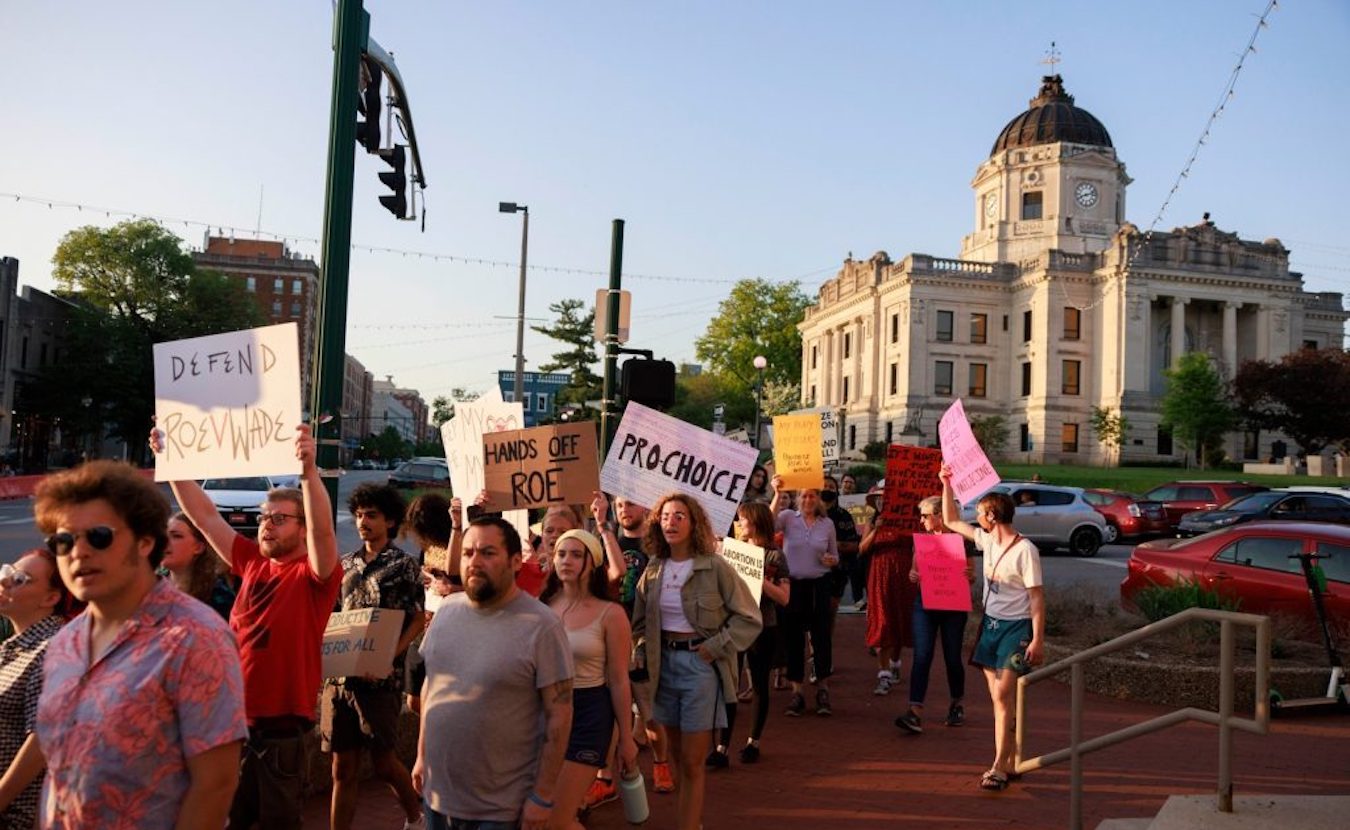 Activists gathered at the Monroe County Courthouse in 2022 for the “Take to the Streets — Defend Roe!” rally and march. Later that year, the U.S. Supreme Court ended federal protection of abortion rights across the country. Indiana then became the first state to pass an anti-abortion law, which, according to advocates for women’s health, has created confusion among doctors and endangered the lives of pregnant women. | Photo by Jeremy Hogan/The Bloomingtonian