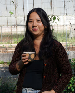 Ash Teng, owner of Blossom & the Bee Tea Co., enjoys a cup of mint tea on her farm in the Hoosier National Forest. | Photo by Anne Kibbler