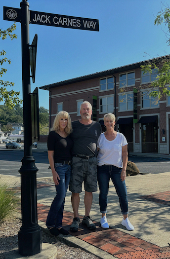 The family of Jack and Jane Carnes stands in French Lick in August 2024 on Jack Carnes Way, the street named for their father. (l-r) Jackie Carnes, John Carnes, and Connie Cox. | Photo by Carol Johnson/Southern Indiana Business Report