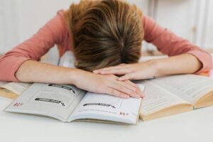 A new study found that 27 percent of teens are actively struggling with burnout. | Photo by <a href="https://www.pexels.com/photo/a-girl-with-books-5877583/" target="_blank">Kaboompics.com</a> 